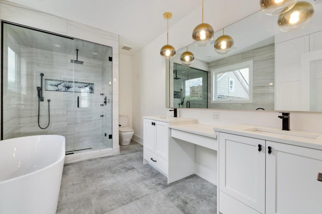 white bathroom with white vanity and gray tile floor